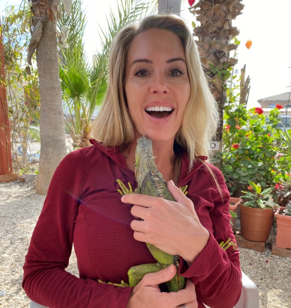 Ann Marie Carvajal holding an iguana